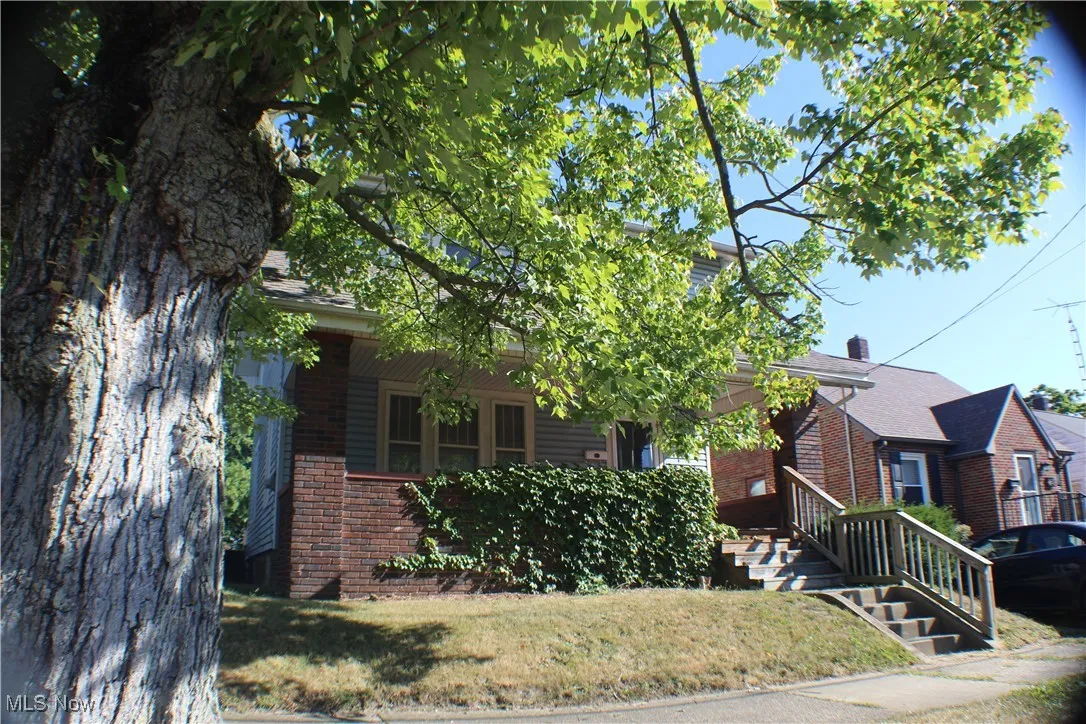 View of front of home with brick siding and a front yard