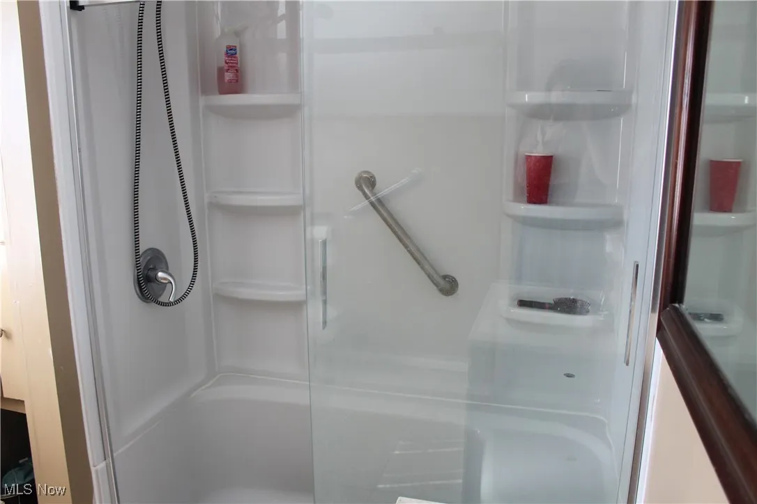Full bathroom with a shower stall
