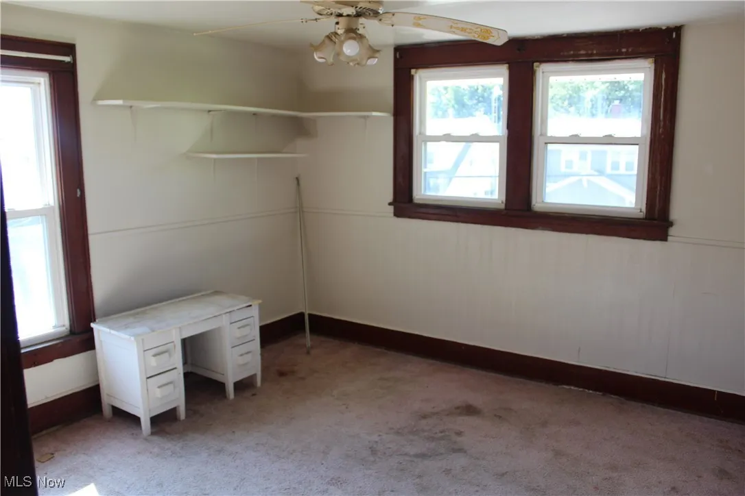Unfurnished bedroom featuring carpet flooring and a ceiling fan