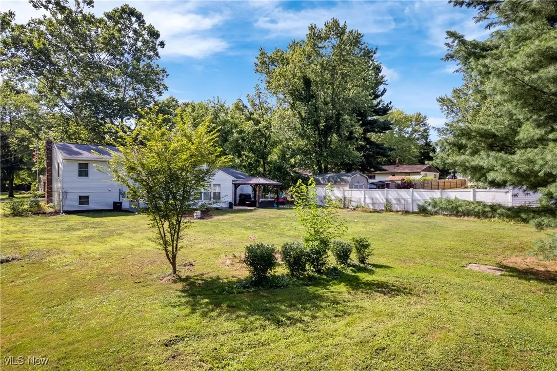 View of yard featuring a gazebo and view of wooded area