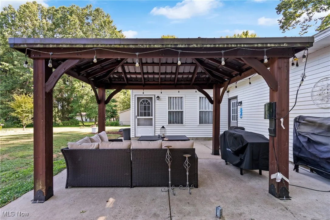 View of patio featuring outdoor lounge area, a gazebo, and grilling area