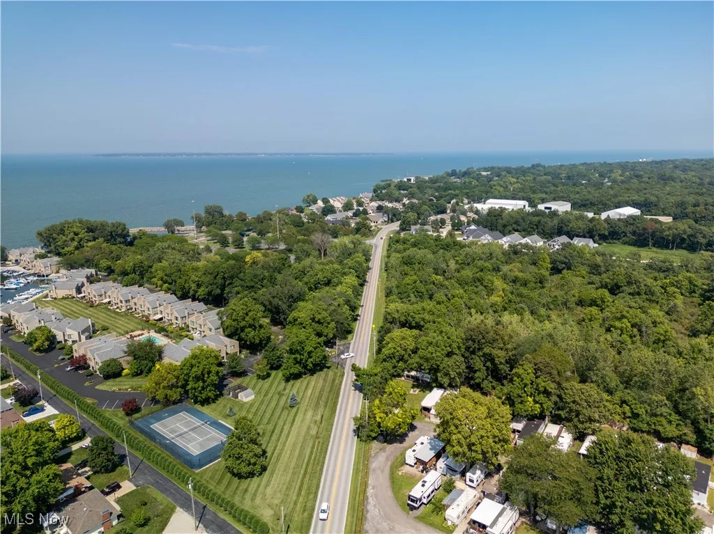 Aerial view of residential area featuring a nearby body of water