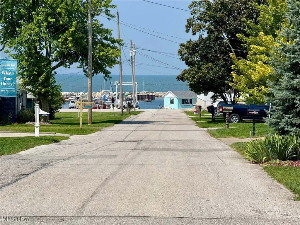 View of asphalt road featuring a water view