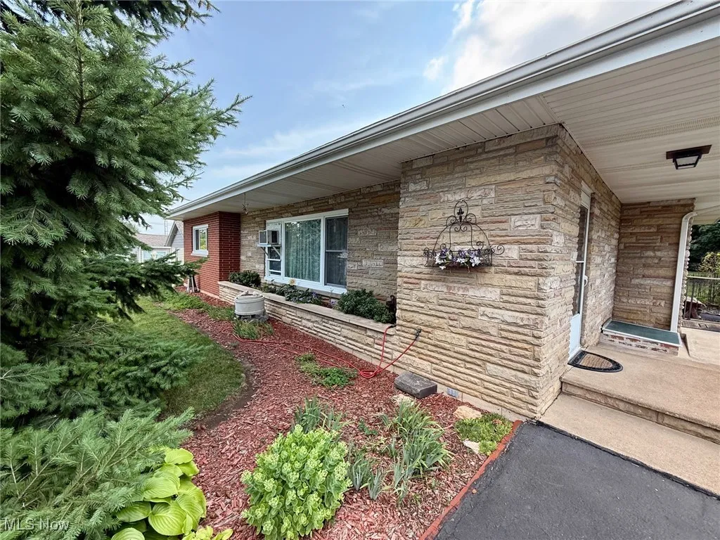 Property entrance with stone siding