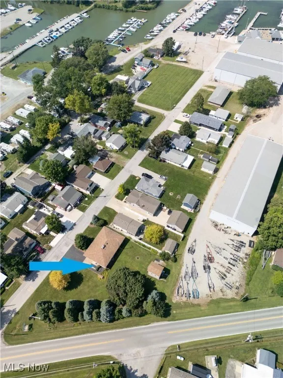 Aerial view of property and surrounding area with a large body of water and nearby suburban area