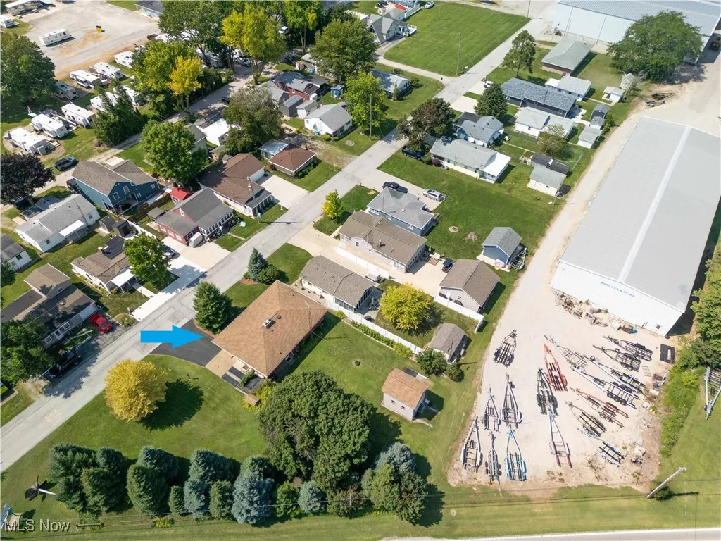 Aerial view of property and surrounding area with nearby suburban area