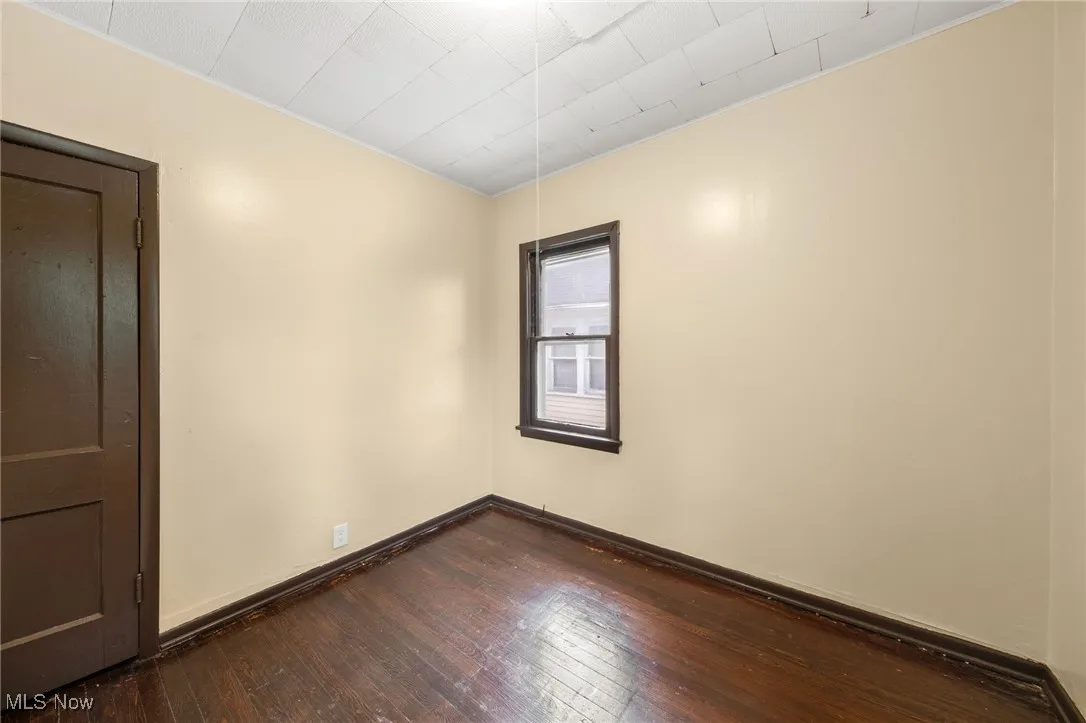Spare room featuring hardwood / wood-style floors and baseboards