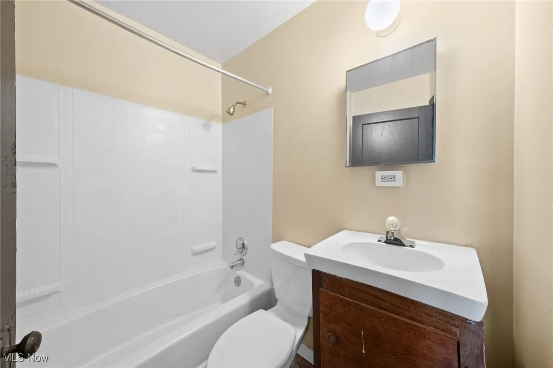 Bathroom featuring shower / tub combination and vanity