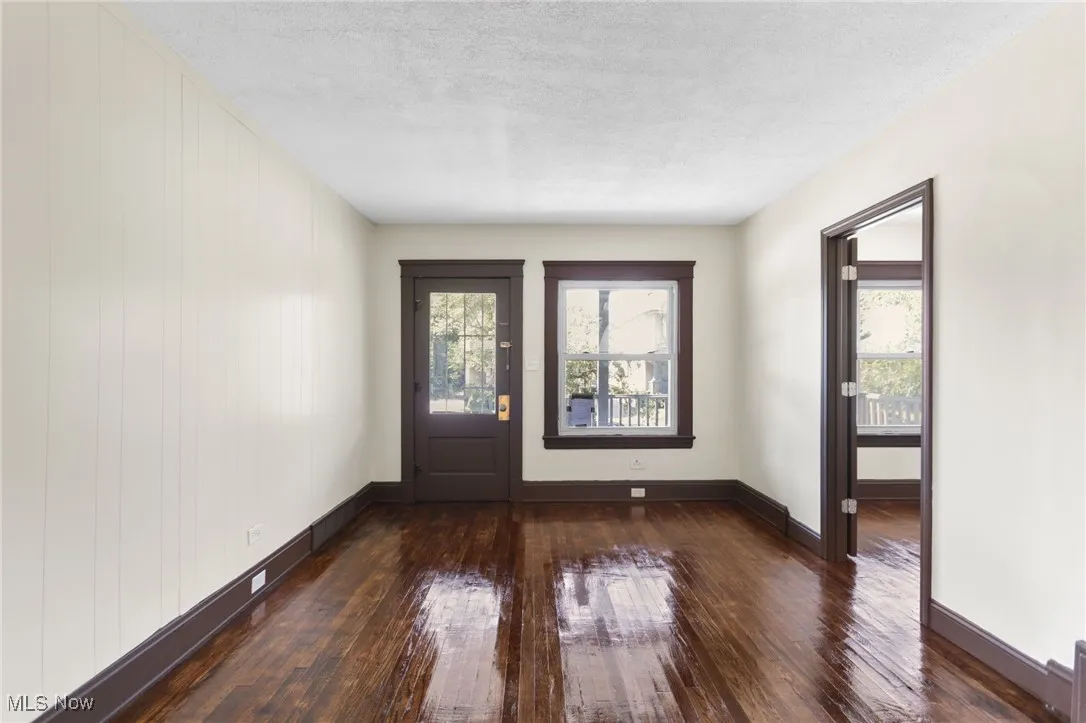 Entrance foyer featuring dark wood-style flooring and a textured ceiling