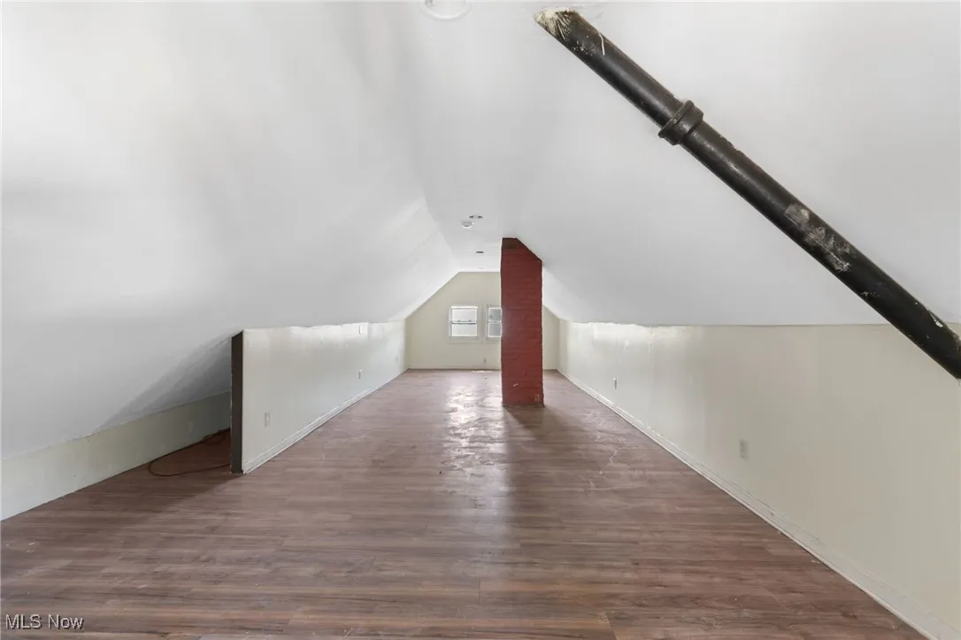 Bonus room featuring wood finished floors and lofted ceiling