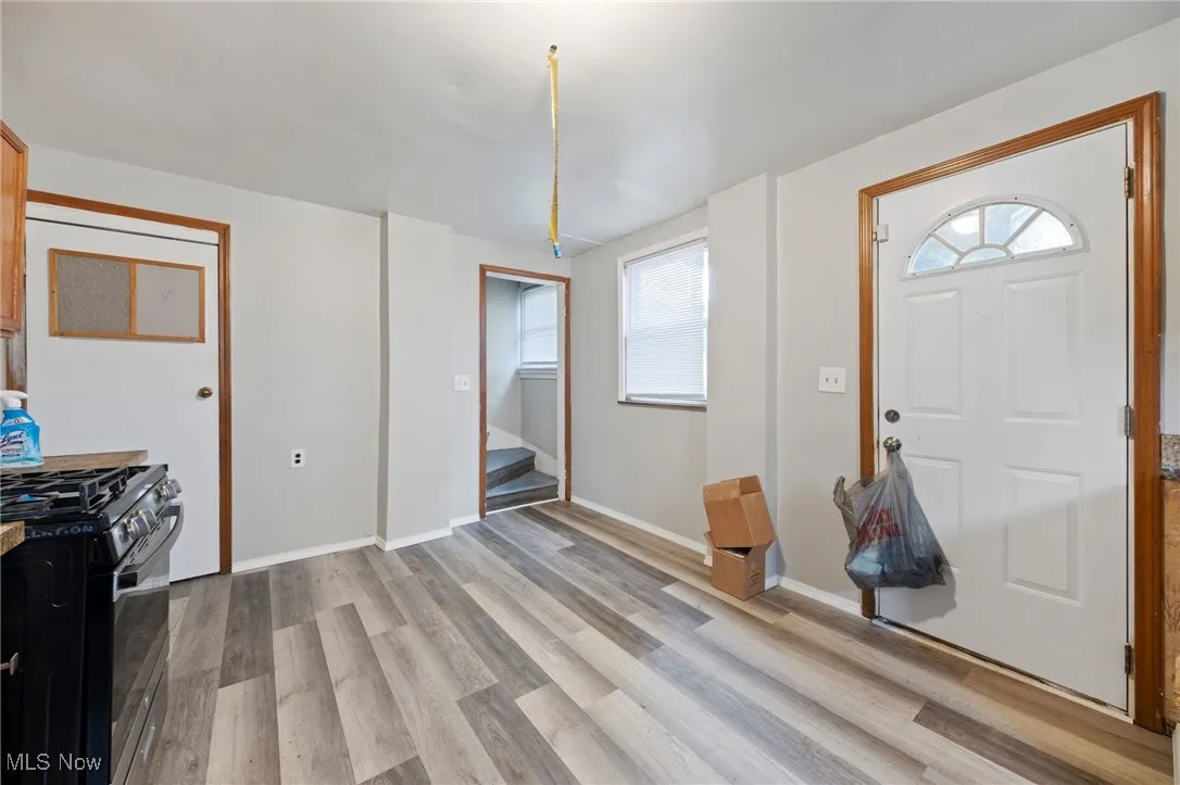 Entryway with light wood-style flooring and stairway