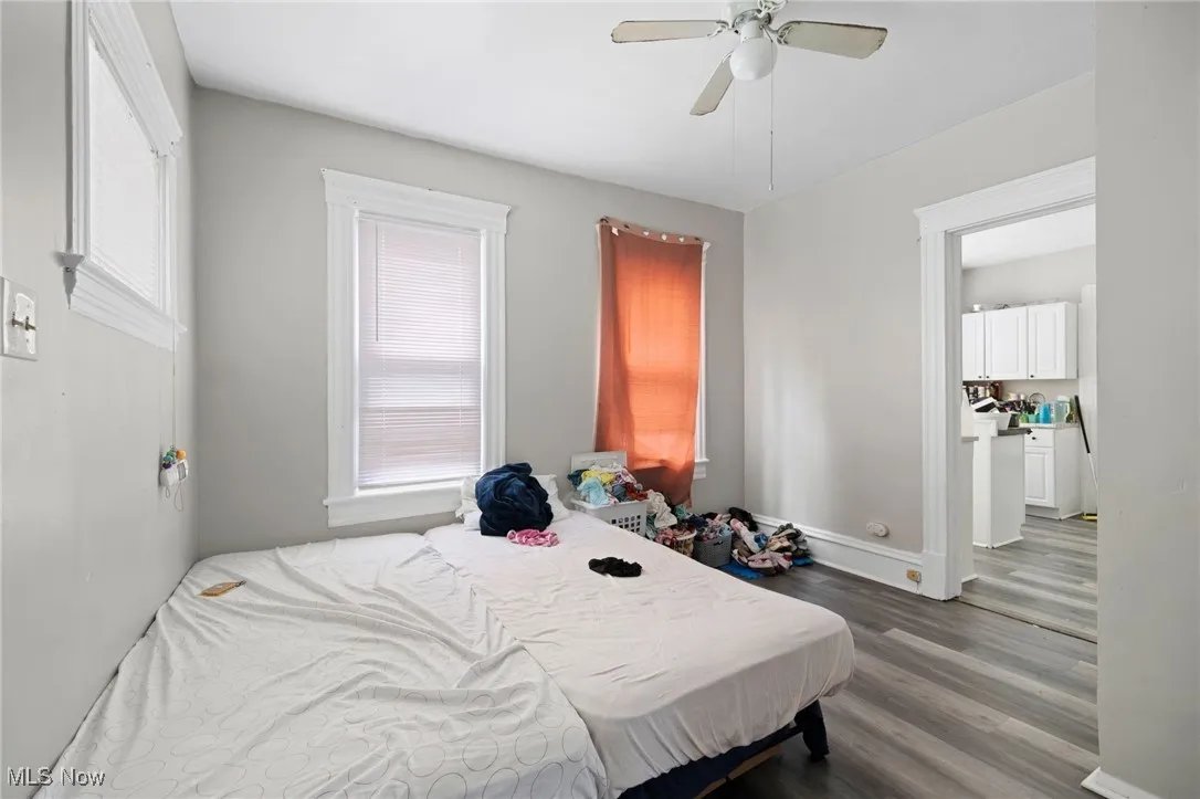Bedroom featuring dark wood-style flooring and ceiling fan