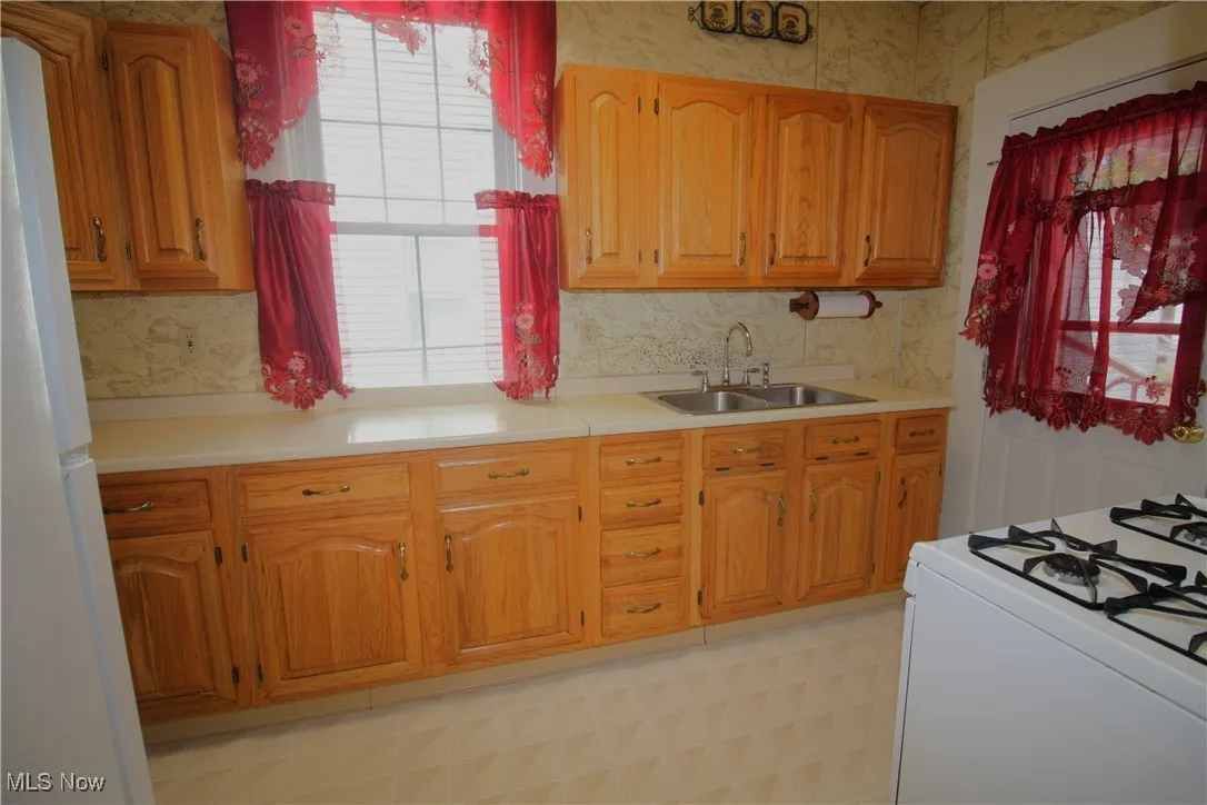 Kitchen with door to back of home and garage.