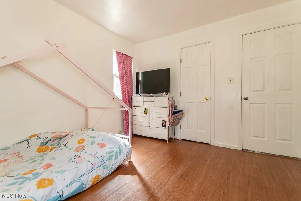 Bedroom with wood finished floors
