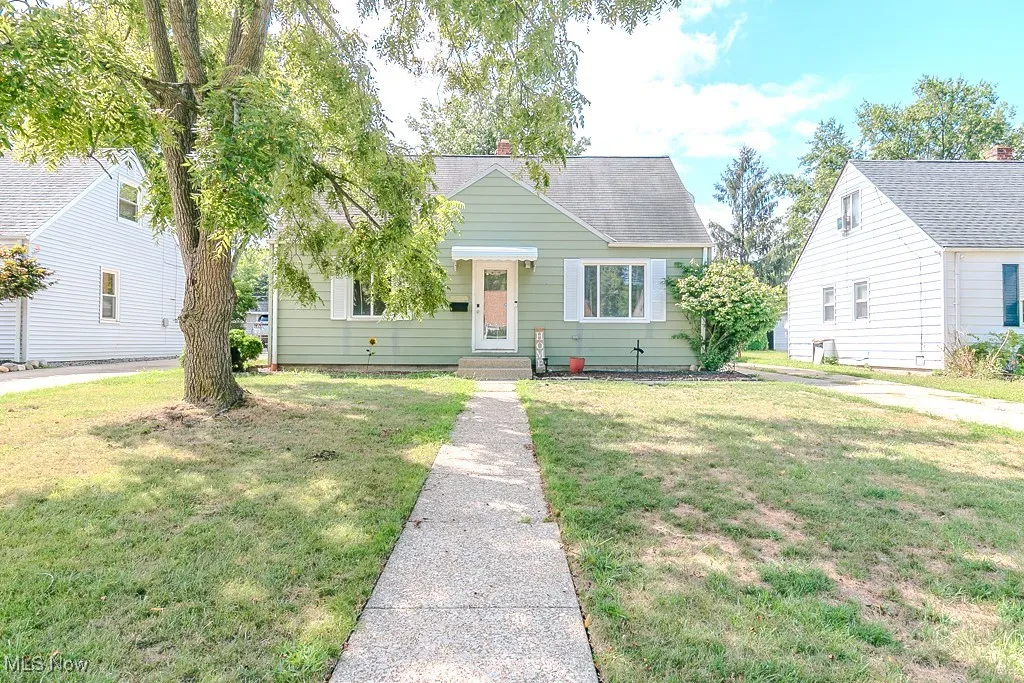 Bungalow-style house featuring a front yard, a chimney, and a shingled roof