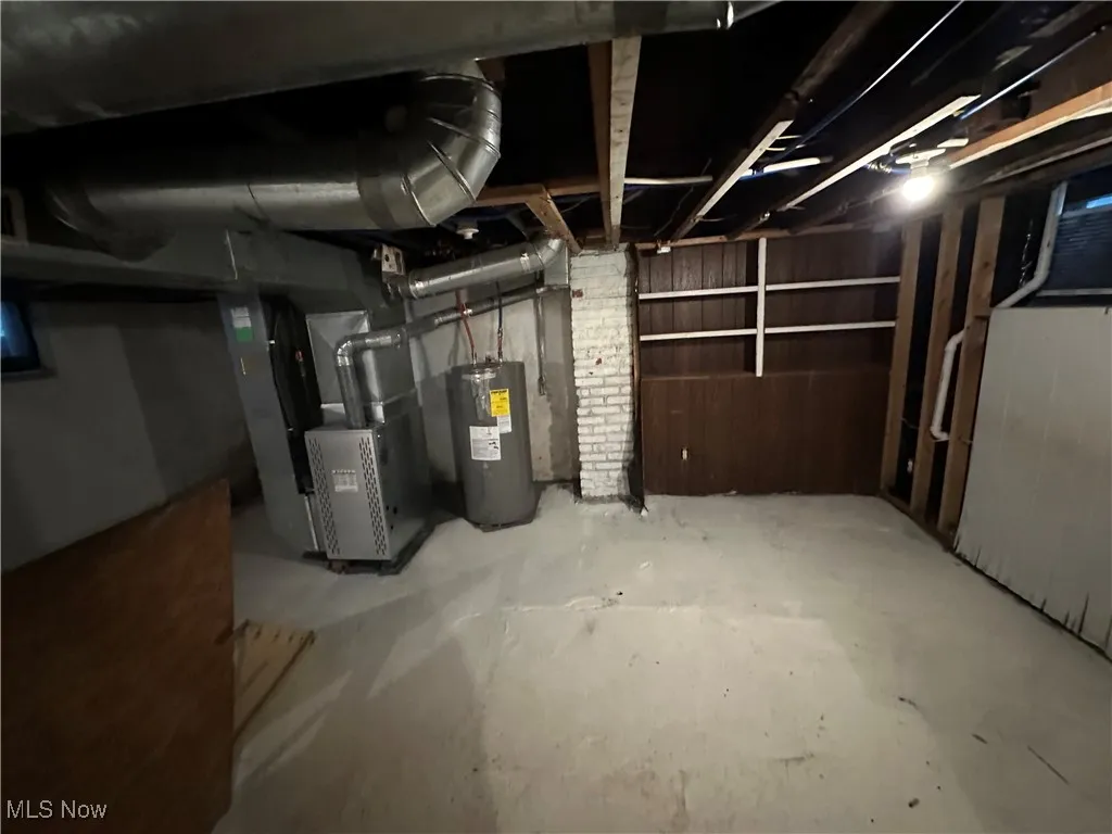 Unfinished basement with water heater and heating unit