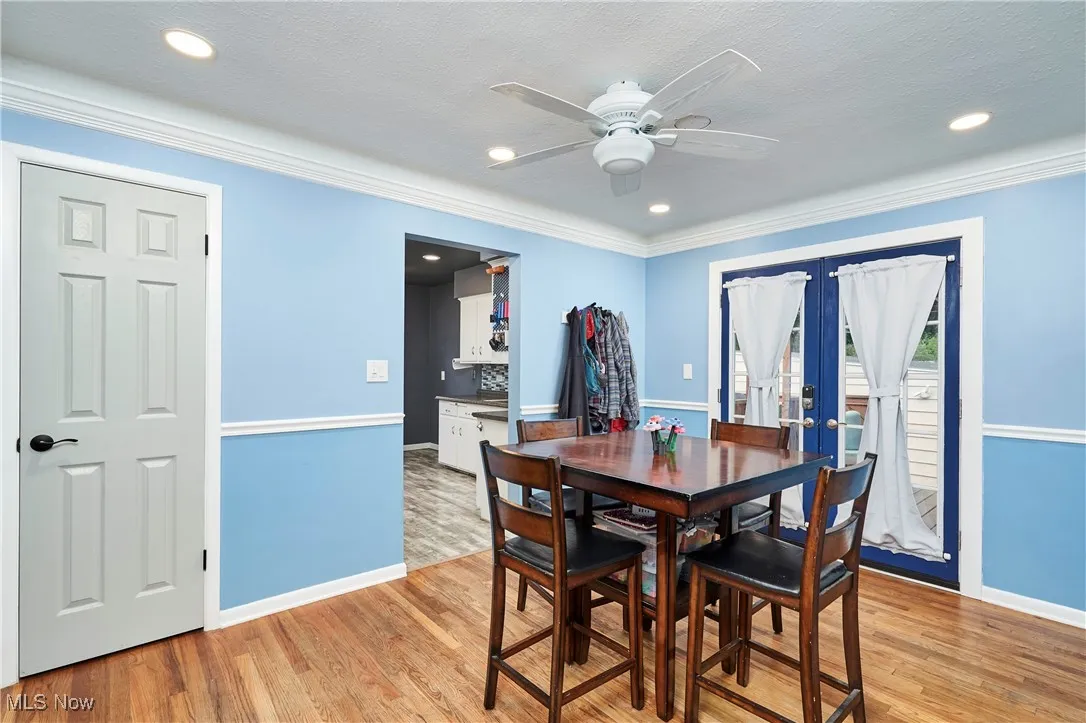 Dining space with french doors, hardwood floors, recessed lighting, a ceiling fan, and ornamental molding