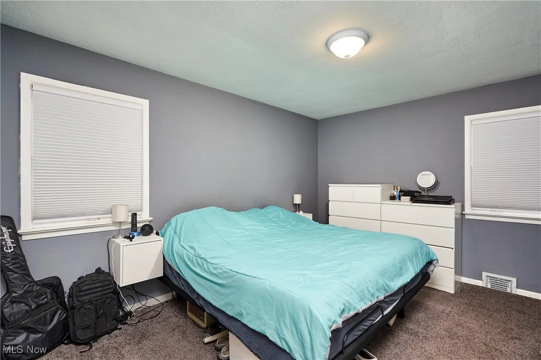 Bedroom with carpet and a textured ceiling