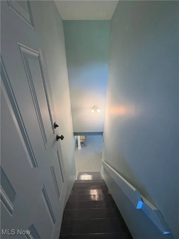 Stairs featuring wood finished floors