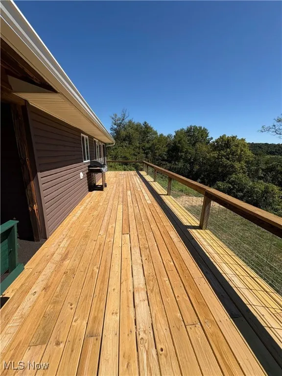 Deck featuring view of wooded area