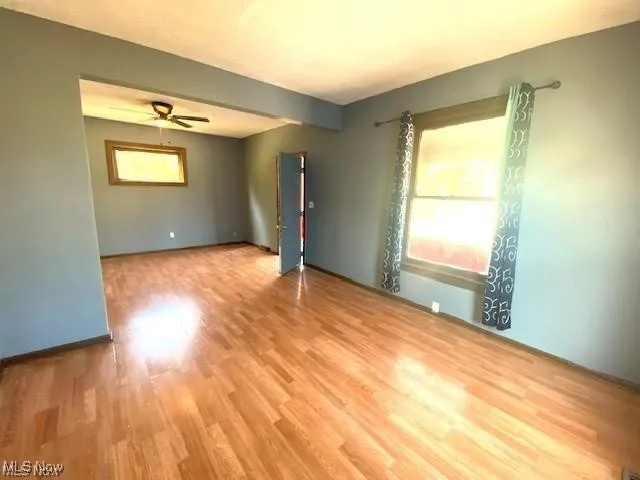 Unfurnished room with light wood-style flooring and a ceiling fan
