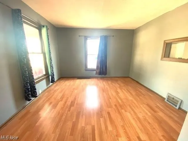 Unfurnished room with light wood finished floors