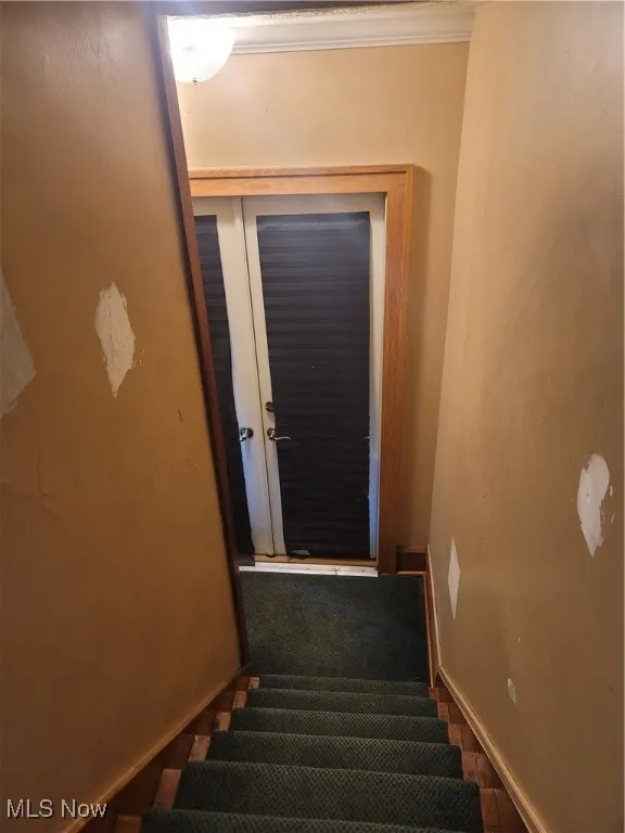 Staircase featuring baseboards