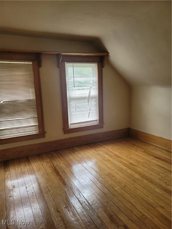 Bonus room featuring wood-type flooring and vaulted ceiling