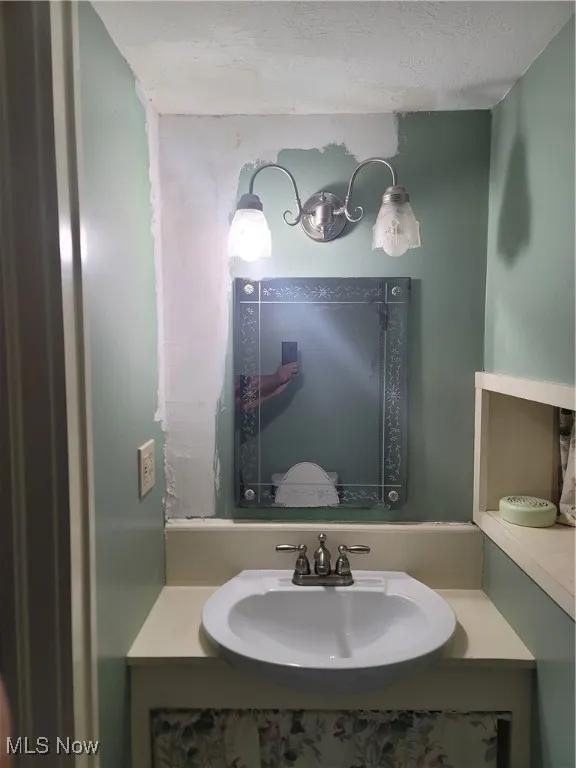 Bathroom featuring vanity and a textured ceiling