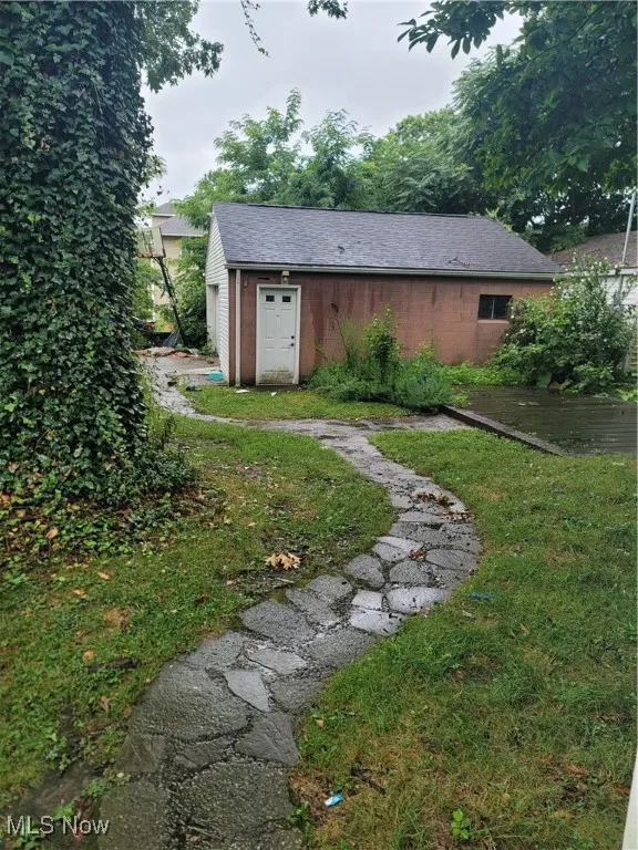 View of grassy yard with an outdoor structure