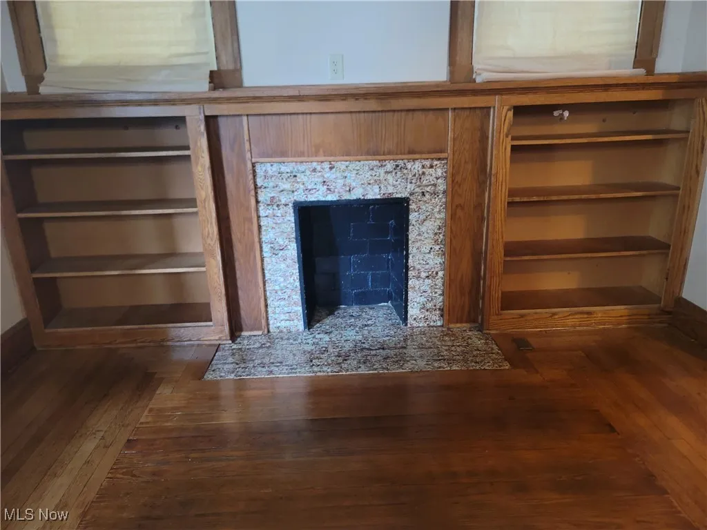 Detailed view of a fireplace and wood finished floors