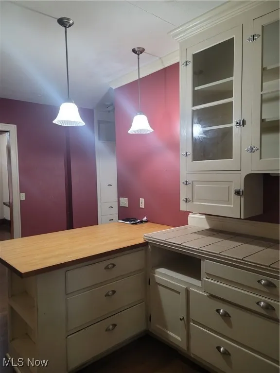 Bathroom featuring crown molding and dark wood-type flooring