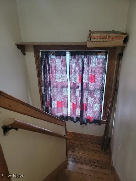 Stairs with hardwood / wood-style floors