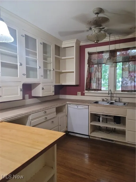 Kitchen with hanging light fixtures, open shelves, dishwashing machine, and crown molding
