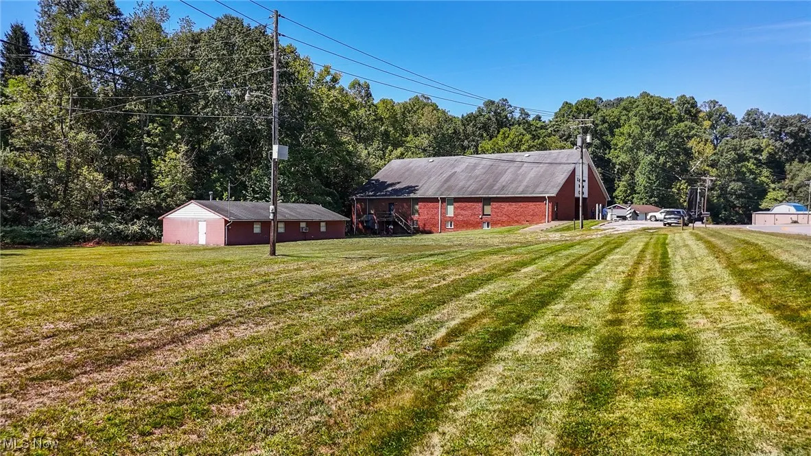 View of grassy yard with an outbuilding