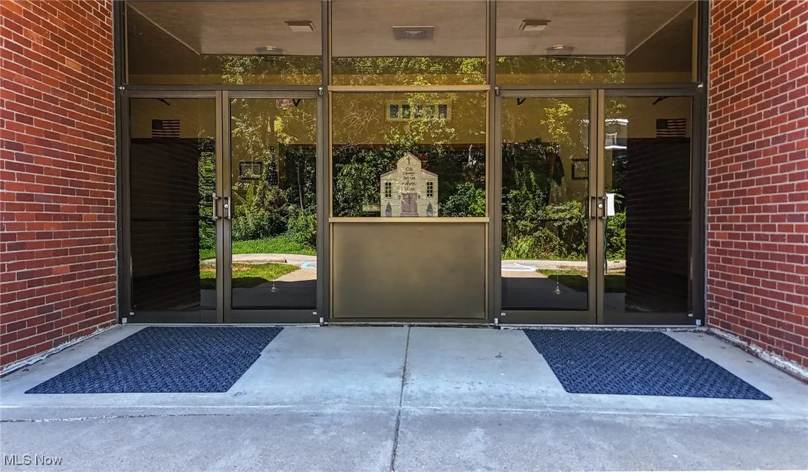 Entrance to property with brick siding and french doors