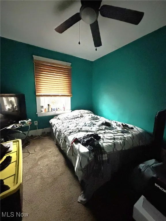 Bedroom with carpet and a ceiling fan