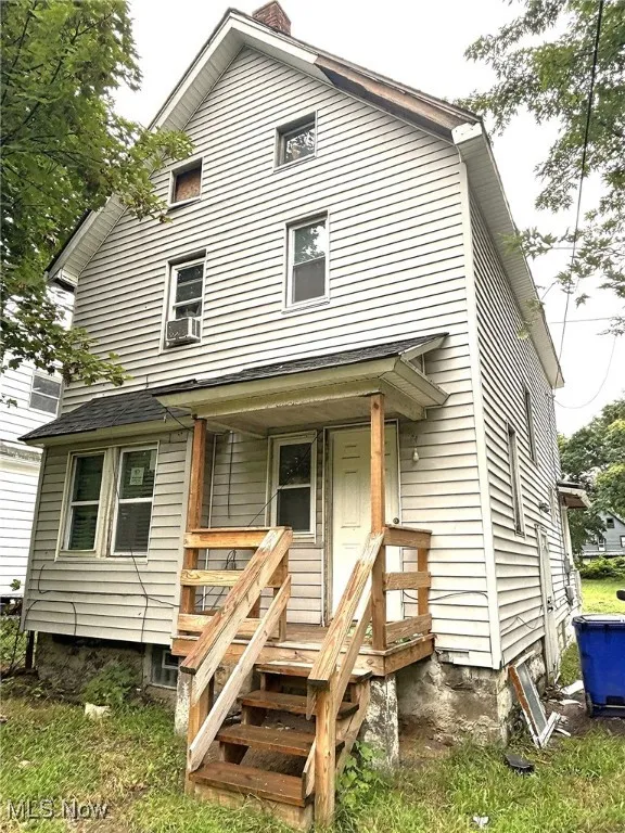 View of front of house featuring covered porch and cooling unit