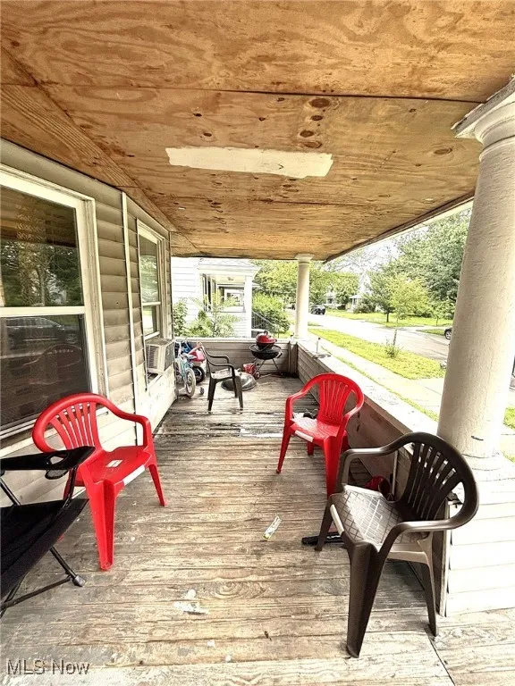 Wooden terrace featuring cooling unit