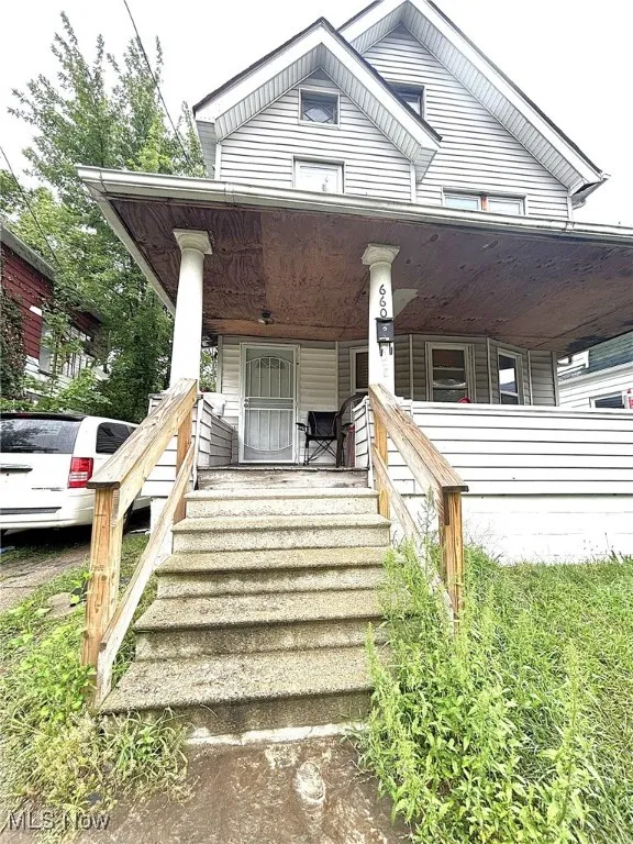 Entrance to property featuring covered porch