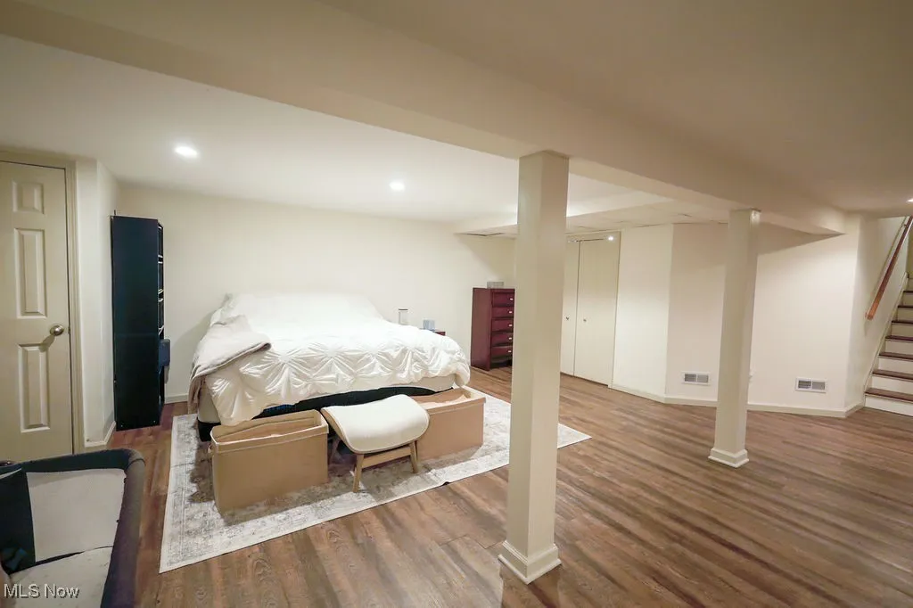 Bedroom with wood finished floors and recessed lighting