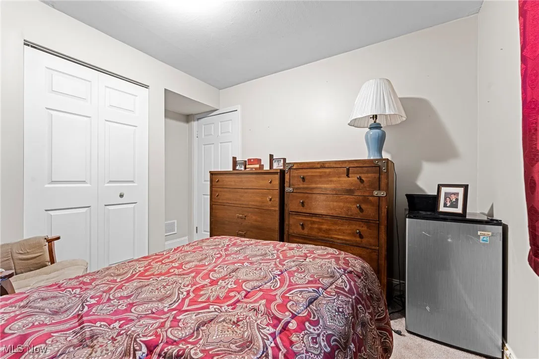 Carpeted bedroom featuring a closet in lower level