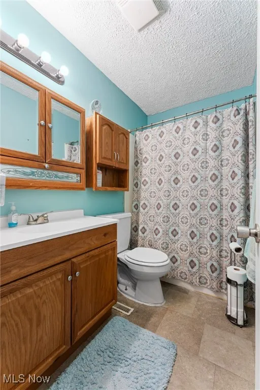 Bathroom with vanity and a textured ceiling