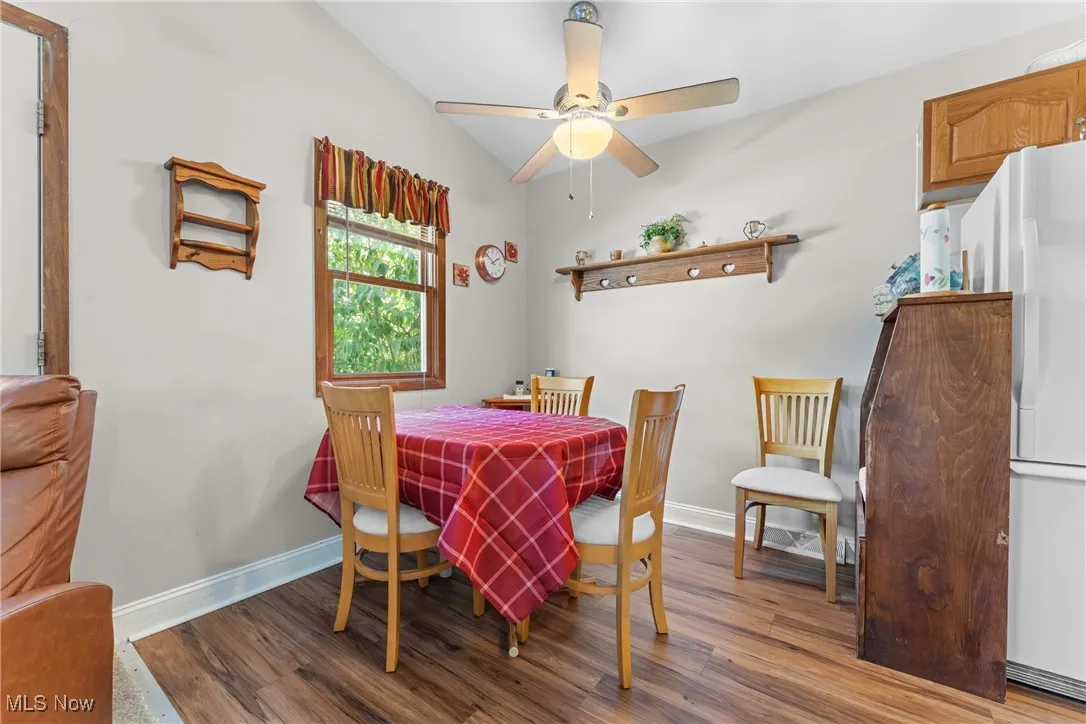 Dining space with wood finished floors and baseboards
