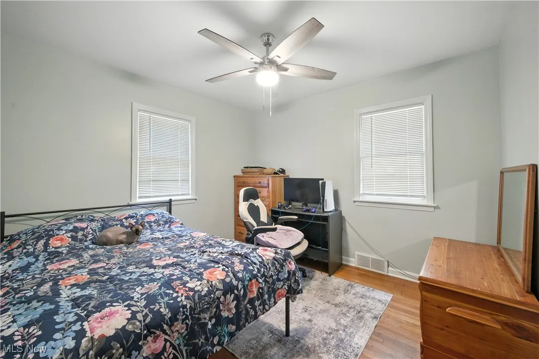 Bedroom with light wood-style floors and a ceiling fan