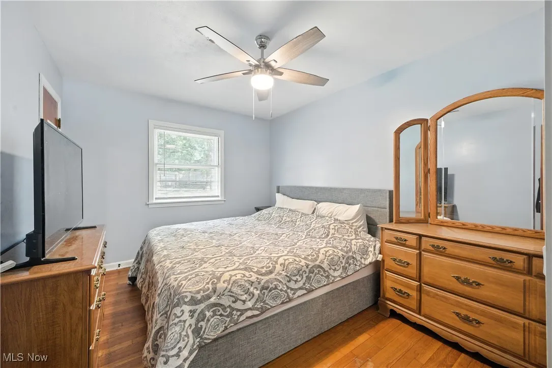 Bedroom with hardwood / wood-style flooring and a ceiling fan