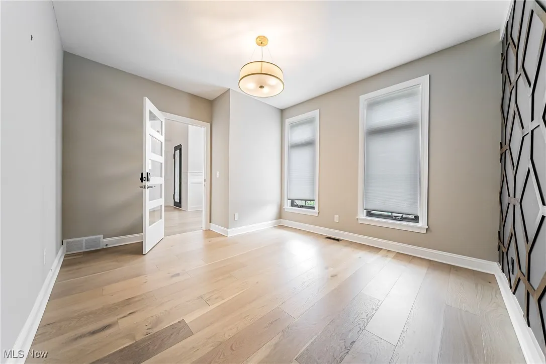 Unfurnished room with light wood-type flooring and baseboards