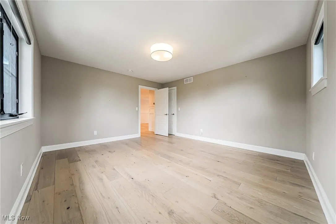 Unfurnished bedroom with light wood-type flooring and baseboards