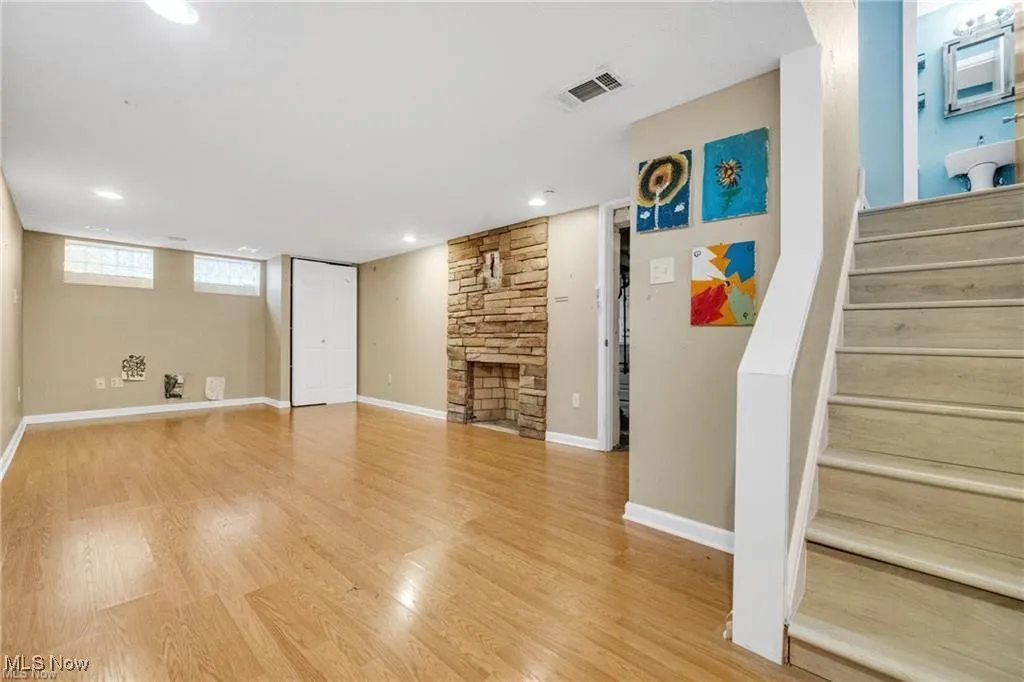 Basement with stairway, light wood finished floors, and recessed lighting
