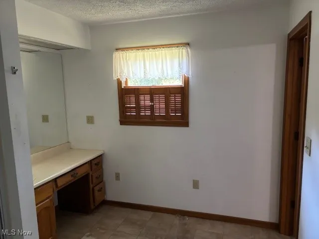 Master Bathroom with a textured ceiling and vanity